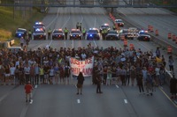 Marchers block part of Interstate 94 in St. Paul, Minn., Saturday, July 9, 2016, during a protest sparked by the recent police killings of black men in Minnesota and Louisiana. (Glen Stubbe/Star Tribune via AP)