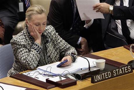 FILE - In this March 12, 2012 file photo, then-Secretary of State Hillary Rodham Clinton checks her mobile phone after her address to the Security Council at United Nations headquarters. An impromptu meeting between Bill Clinton and the nation's top cop could further undermine Hillary Clinton’s efforts to convince voters to place their trust in her, highlighting perhaps her biggest vulnerability. (AP Photo/Richard Drew)