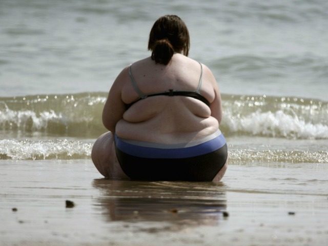 Obese woman beach getty 640x480