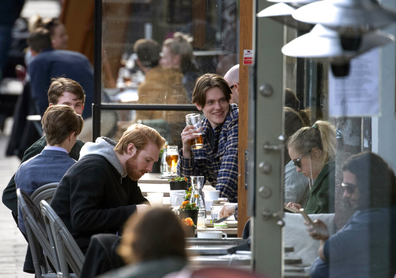 People enjoy themselves at an outdoor restaurant, amid the coronavirus outbreak, in central Stockholm, Sweden, Monday April 20, 2020. (Anders Wiklund/TT News Agency via AP)